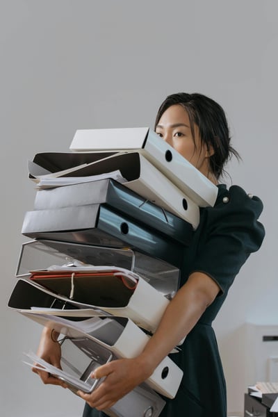 Woman balancing folders