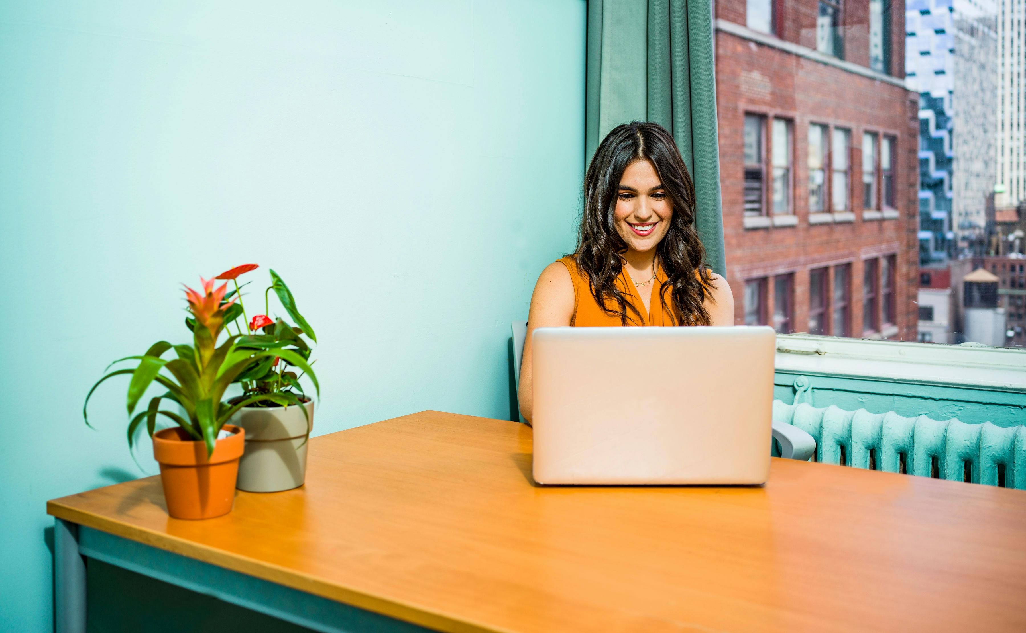 woman on a laptop looking happy