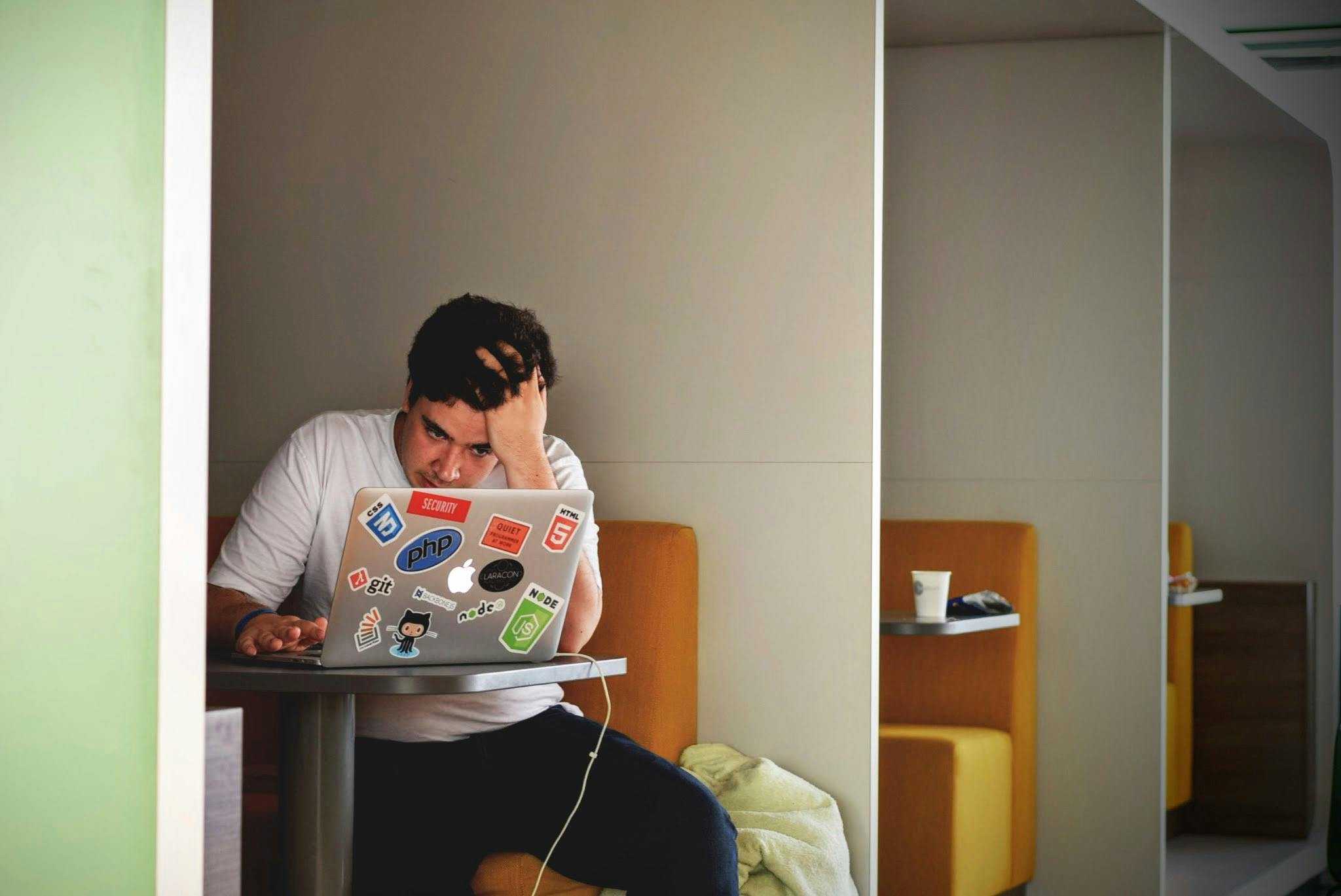 Man on laptop looking desperate